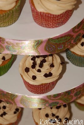 Three tier tower filled with Cookie Dough Cupcakes with chocolate chip sprinkles on top.