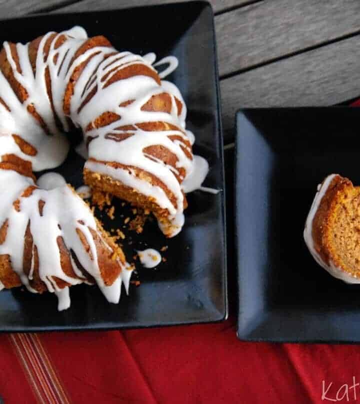 Pumpkin Spice Bundt Cake with Buttermilk Icing plated next to plate of one slice of bundt cake.