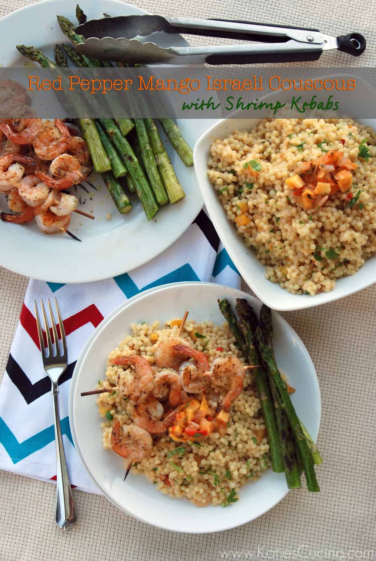 Top view of two plates with shrimp skewers sitting on top of israeli couscous.