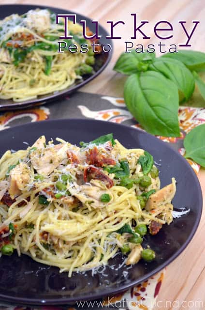 Two purple plates filled with pasta, turkey, spinach, and peas.