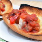 Toasted long subway bread filled with italian sausage, melted, cheese, tomatoe.