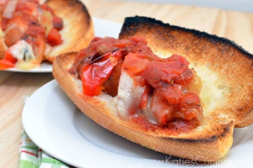 Toasted long subway bread filled with italian sausage, melted, cheese, tomatoe.