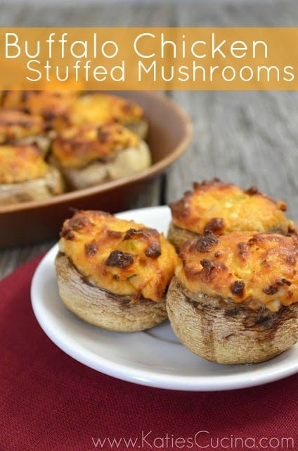 Buffalo Chicken Stuffed Mushrooms on a white plate with more in the background.