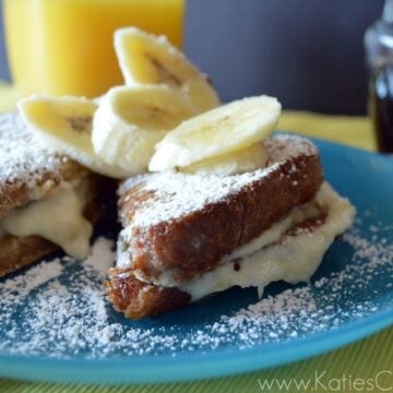 Plated French Toast topped with powdered sugar and banana slices.