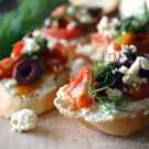 Crostini topped with whipped feta, tomato, kalamata olives and dill.