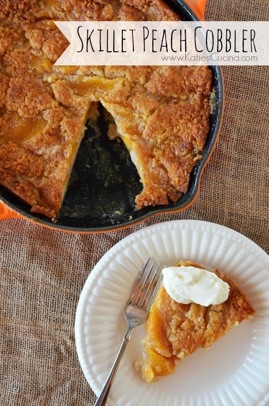 Top view of a skillet with a slice of peach cobbler from it on a white plate topped with whipped cream.