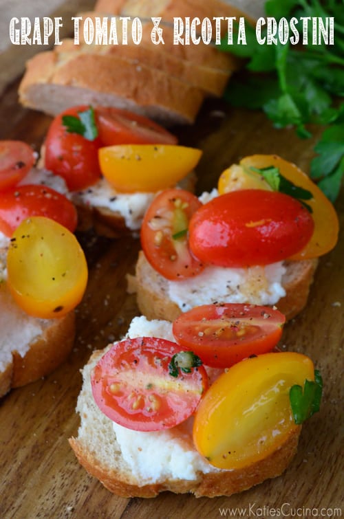 Four slices of crostini top with ricotta and tomatoes with text on image for Pinterest.