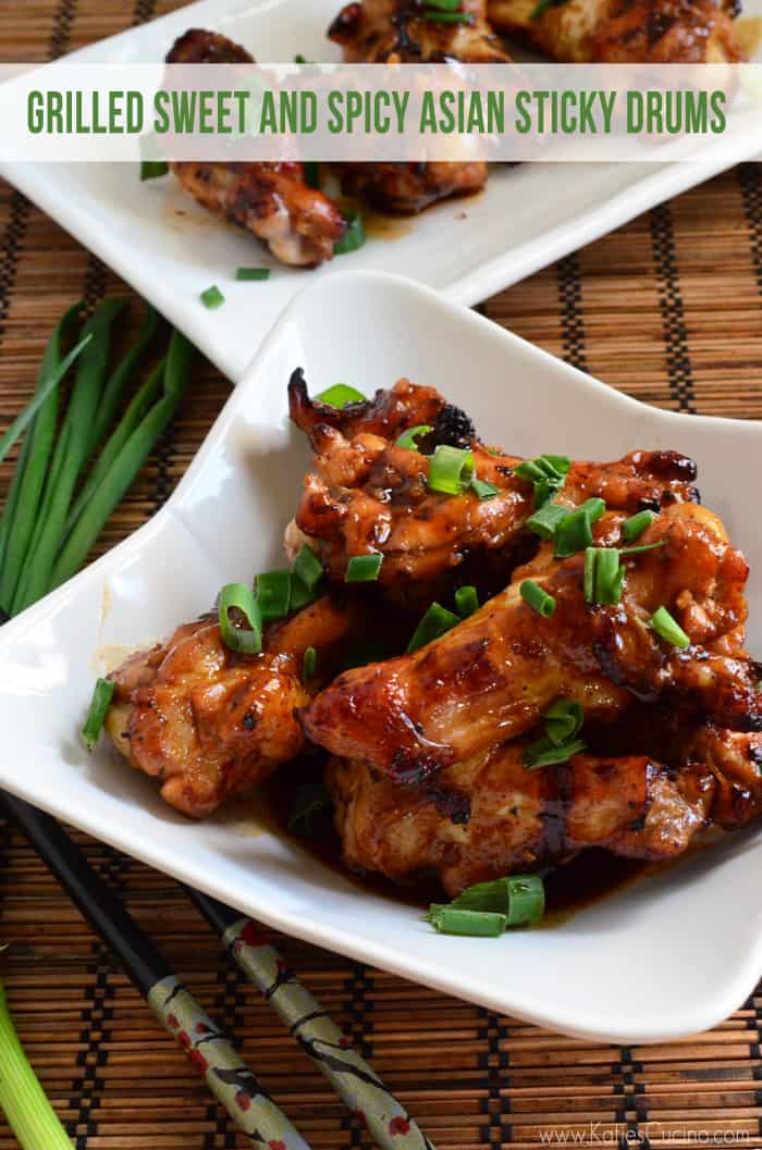 White square bowl filled with brown stick wings topped with green onions.