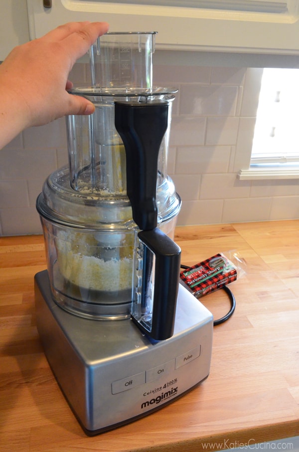 Female hand holding a food processor shredding cheese.