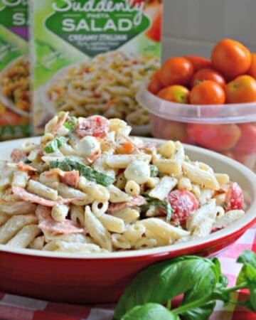 Red platter filled with a creamy pasta salad.