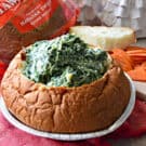 bread bowl filled with spinach dip.