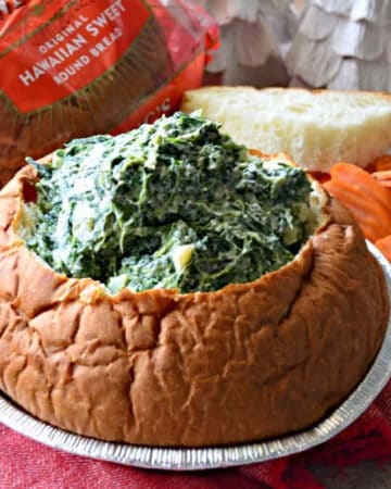 bread bowl filled with spinach dip.