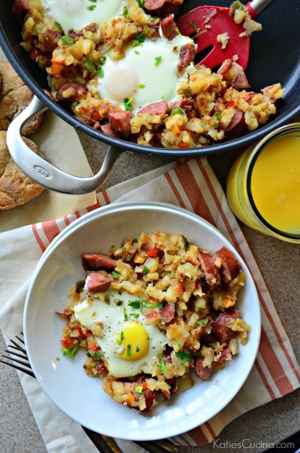 Overhead shot of the Kielbasa Breakfast Skillet with Eggs and a bowl filled with the eggs, keilbasa and potatoes.