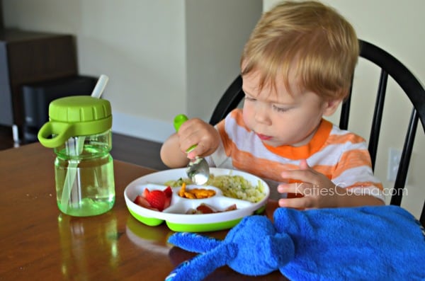 Toddler using OXO Tot feeding set