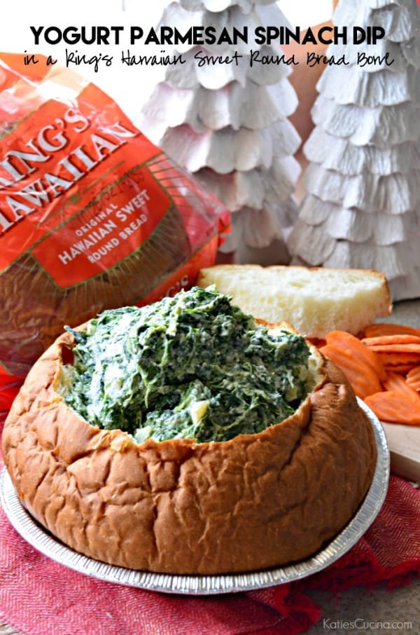 Bread bowl filled with spinach dip with King's Hawaiian Bread package in background and recipe title text on image.