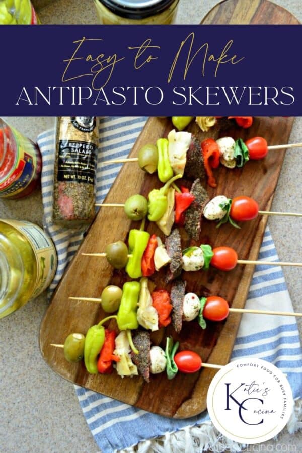 Top view of a wooden cutting board with meat and vegetables skewers on it with text on image for Pinterest.