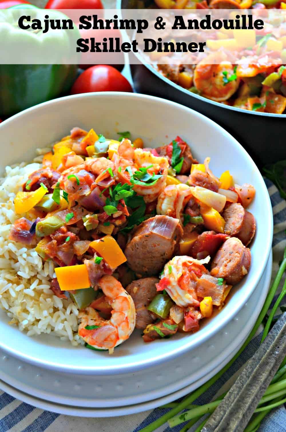 White bowl stacked on plates filled with sausage, shrimp, peppers on top of white rice.