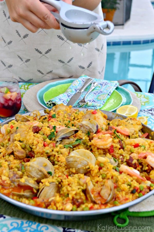 Seafood Paella Party squeezing lemon juice #CelebrateOutdoors