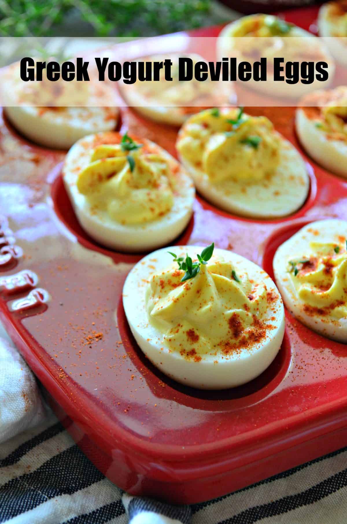 closeup top view of deviled eggs sprinkled with paprika in red egg holder with title text.