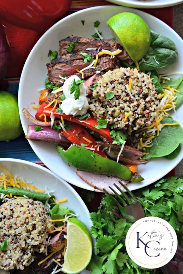 Top view of two white bowls filled with quinoa, steak, and veggies with logo on right corner.