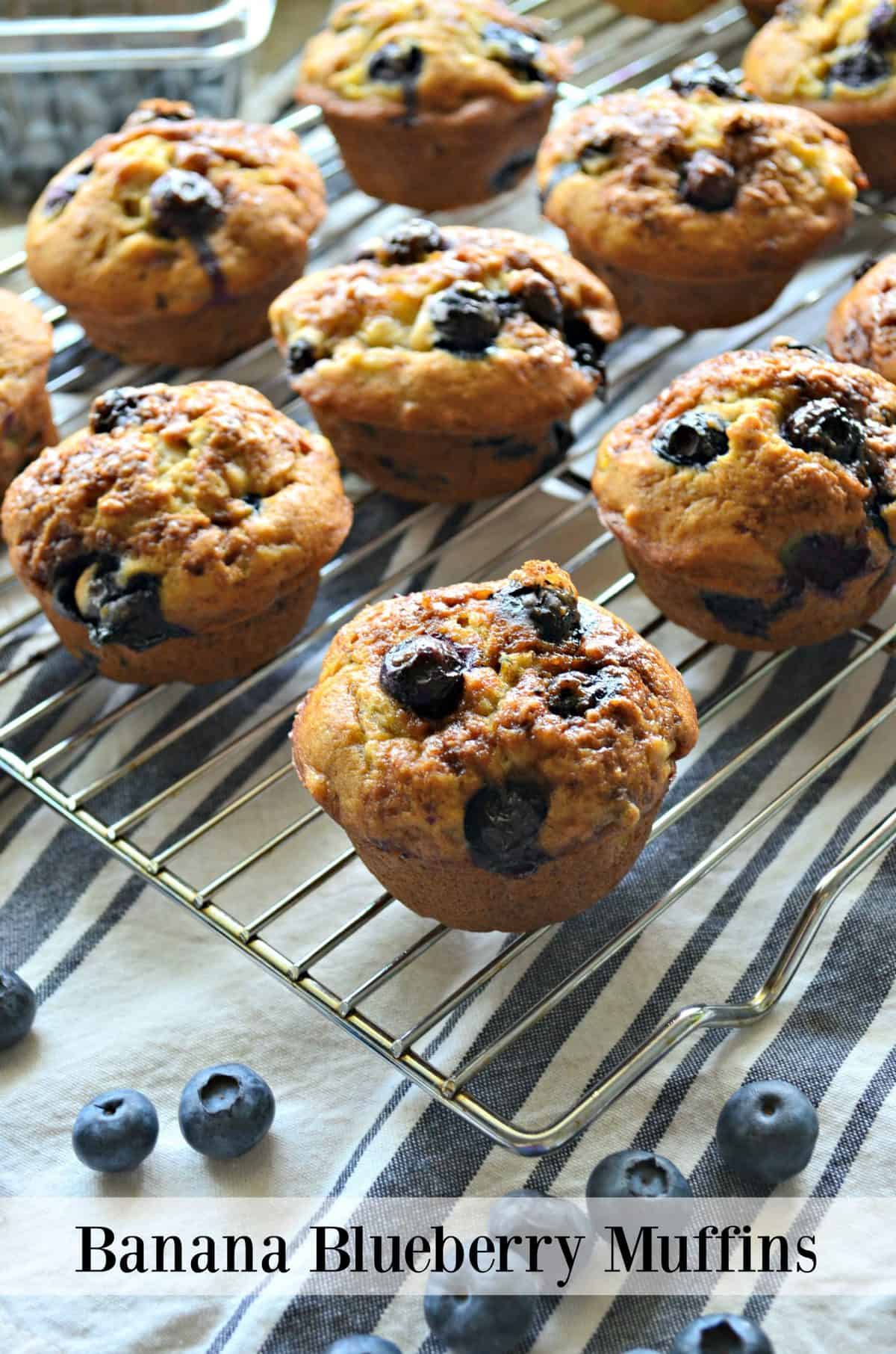 closeup side view of Banana Blueberry Muffins on metal resting rack with title text.