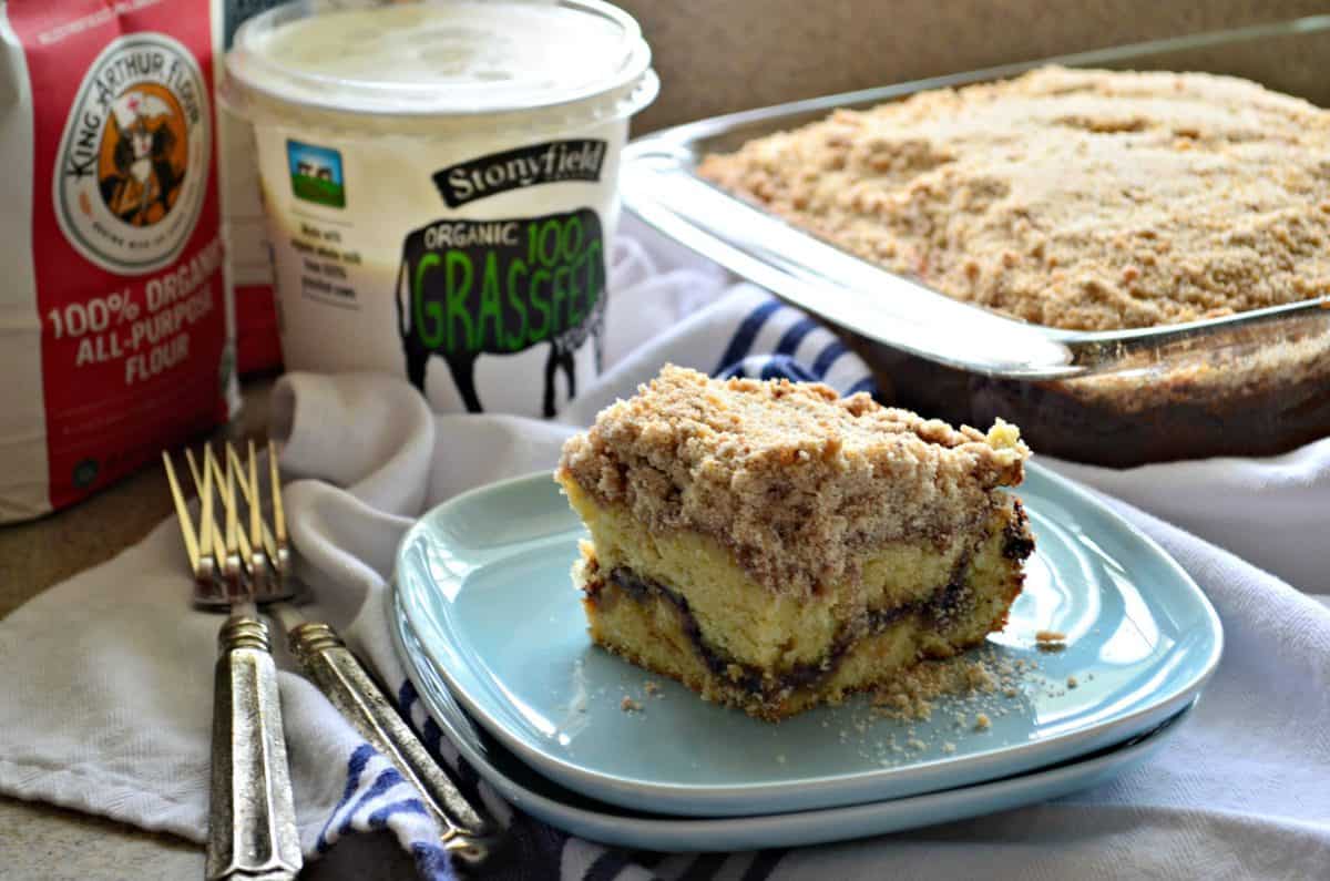 A square slice of Cinnamon Streusel Yogurt Coffeecake on a blue plate with forks.