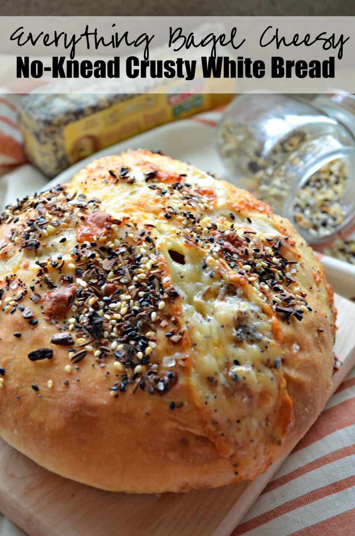 closeup of Cheesy No-Knead Crusty White Bread sprinkled with everything bagel seasoning with title text.