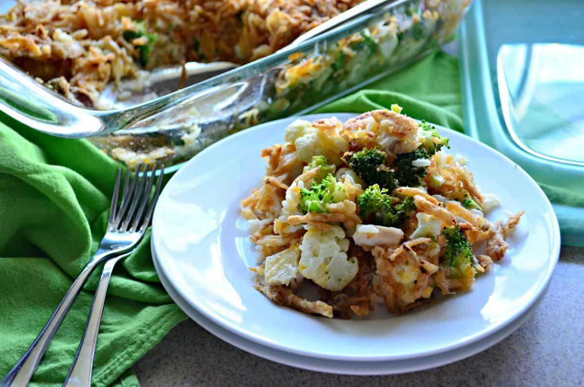 top view of Chicken Rice and Broccoli Casserole topped with crispy onions plated next to silverware.