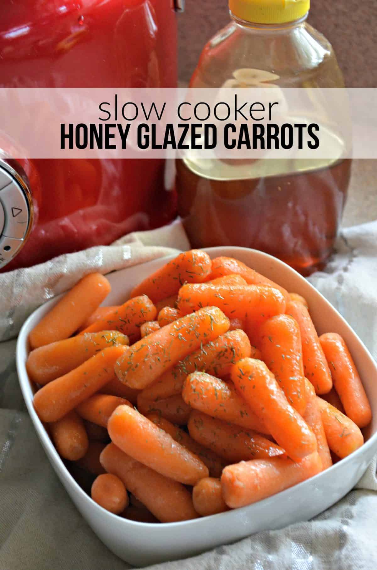 Slow Cooker Honey Glazed Carrots with dried herbs in white bowl on tablecloth.