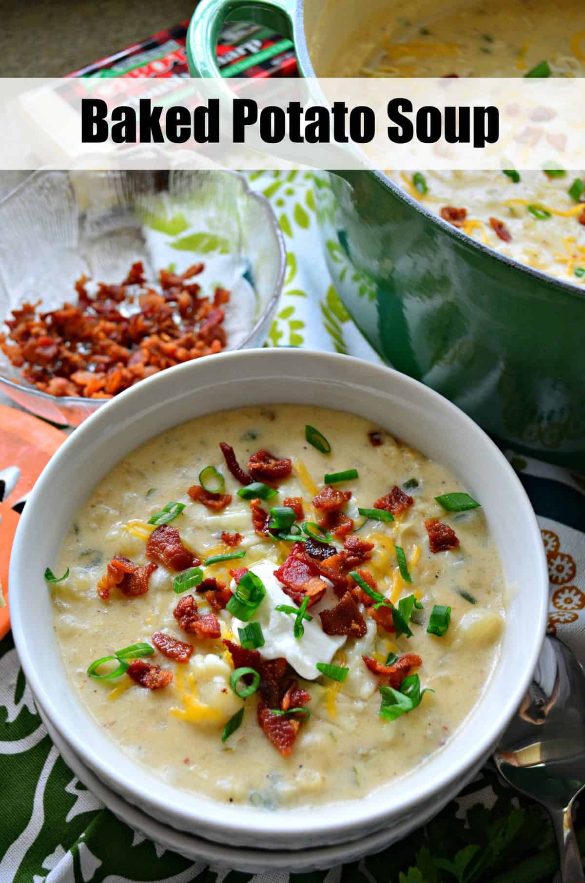 top view of potato soup in white bowl topped with chives, bacon bits, cheese, and sour cream with title text.