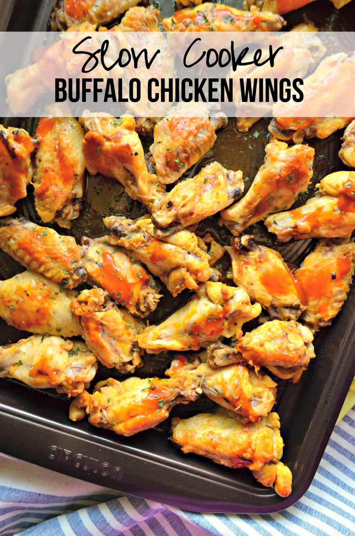 top view closeup of wings smothered in buffalo sauce and spices on sheet pan with title text.