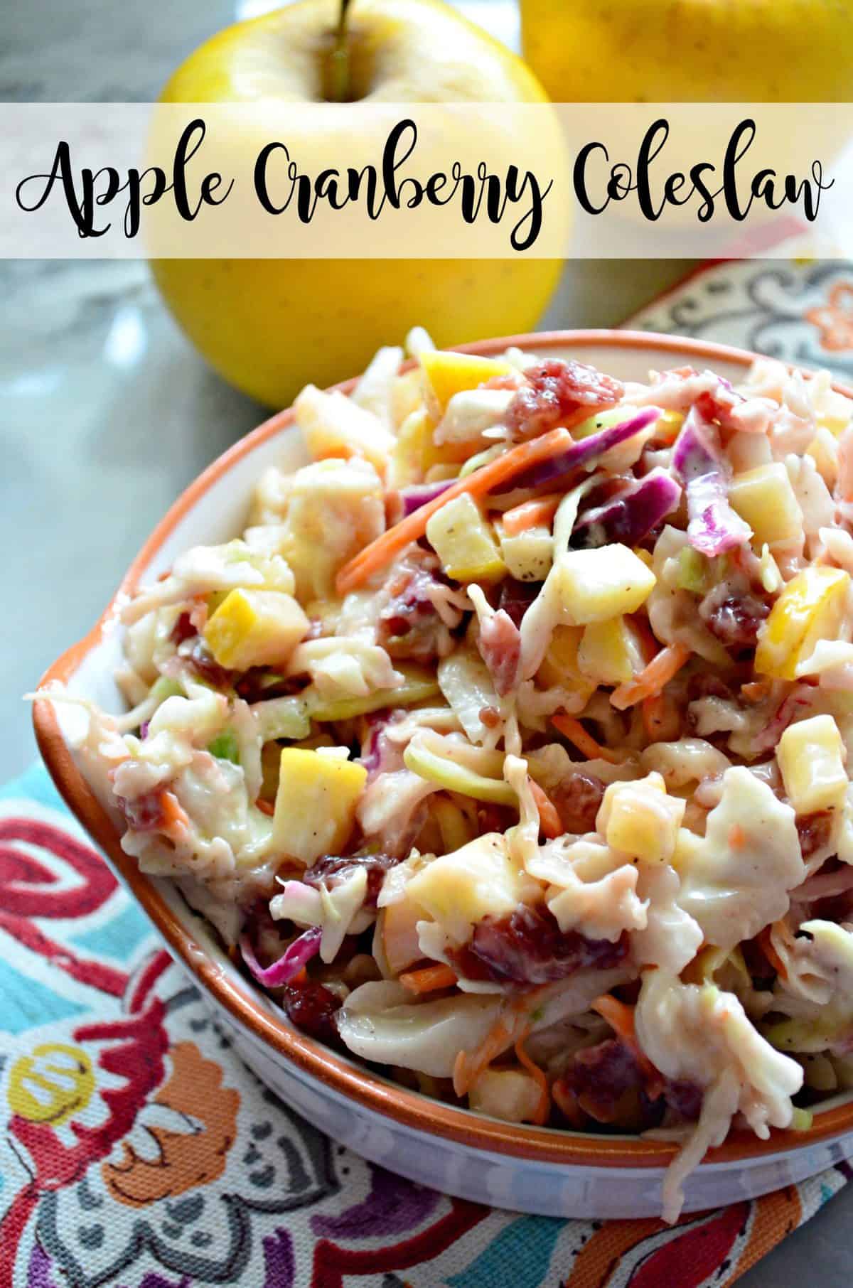 close up top view of shredded carrots, cabbage, and apple slices with sauce in small bowl with title text.