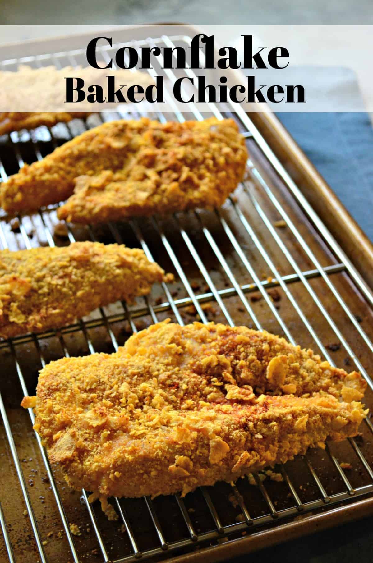 4 large chicken thighs or breasts baked and coated in golden brown corn flakes on rack over top of sheet pan.