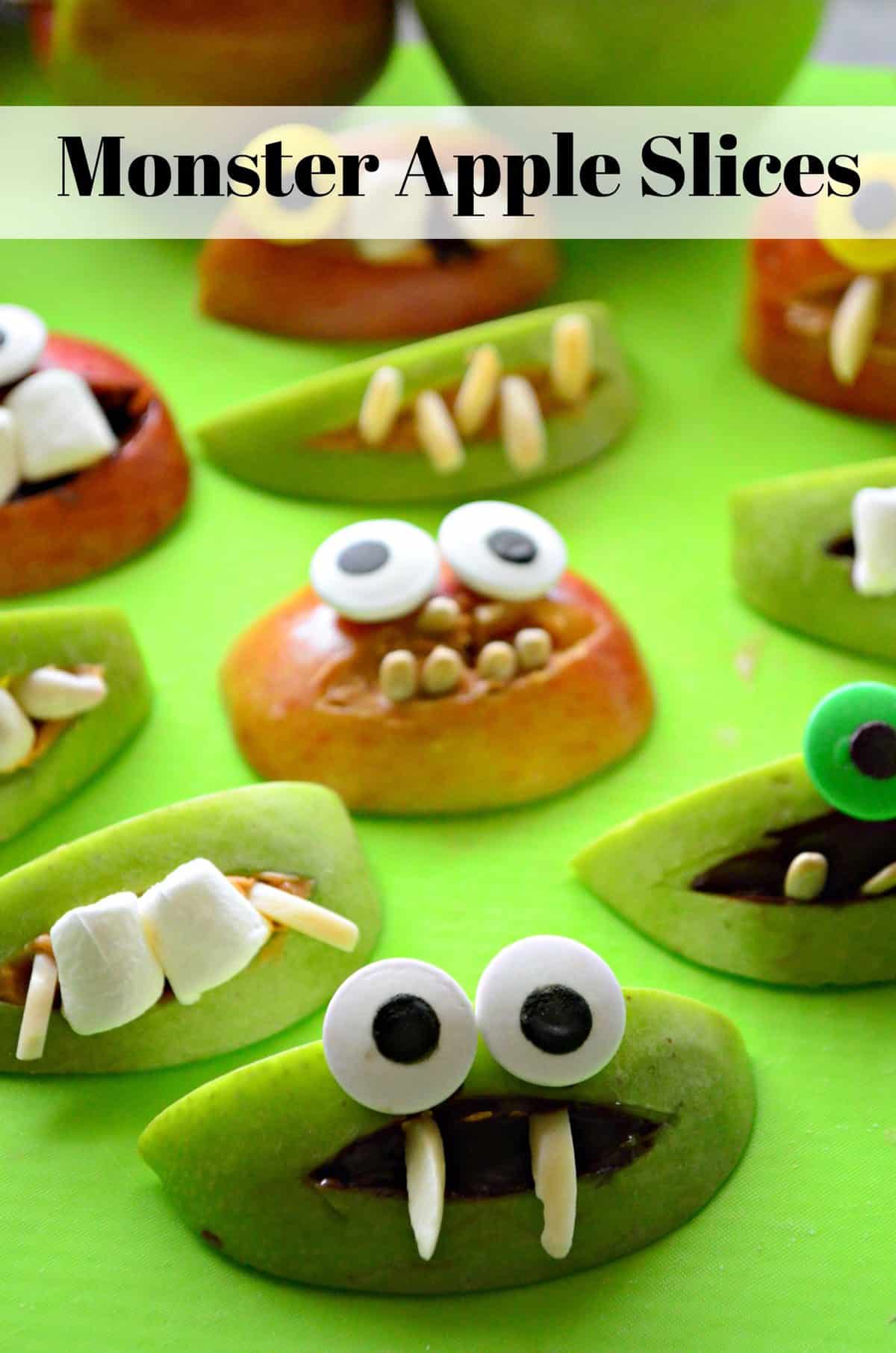 assorted apple slices decorated with peanut butter, nuts, marshmallows, and googly eyes to look like monsters.