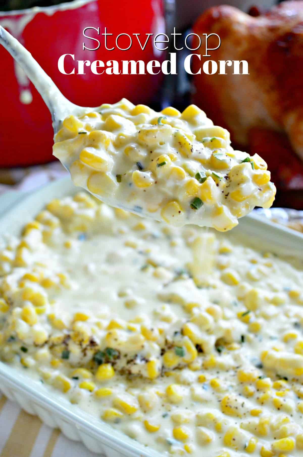 spoonful of creamy corn with pepper and herbs held over casserole dish of creamed corn with title text.