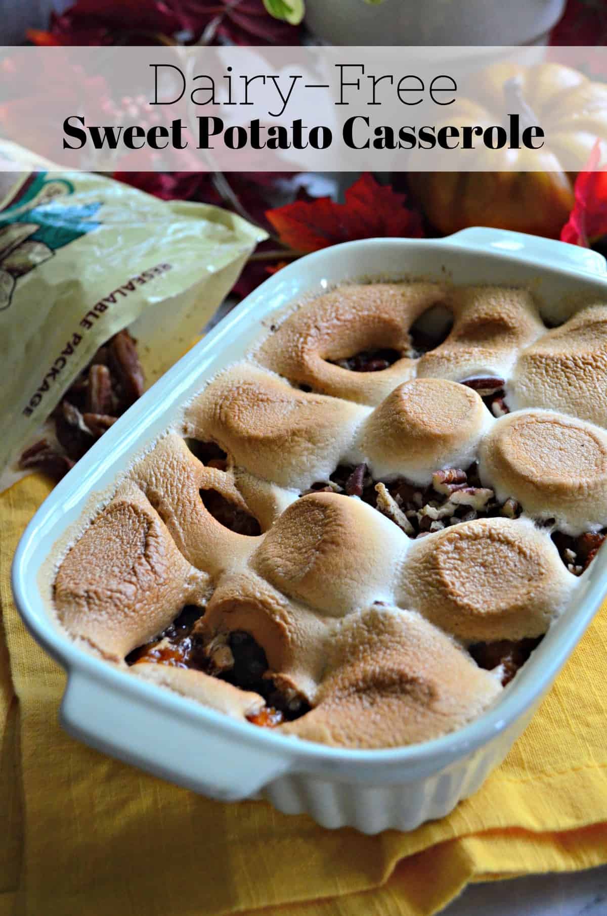 light blue casserole dish with deep orange substance peeking through layer of golden brown melted marshmallows.
