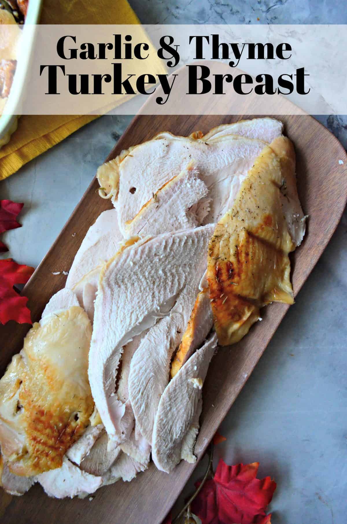 sliced Garlic & Thyme Turkey Breast on wooden cutting board with title text.