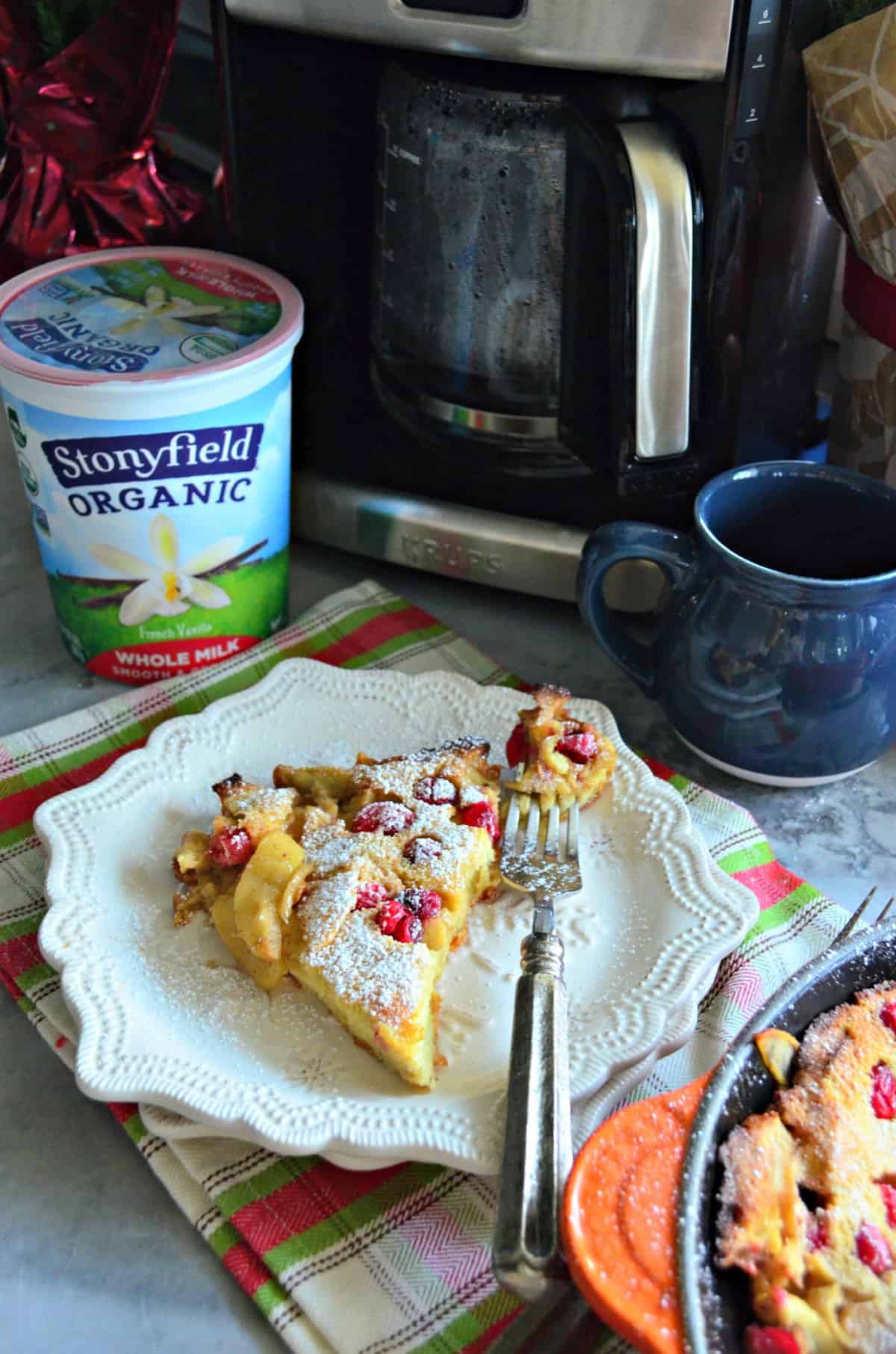 plated slice of dutch baby in front of stoneyfield organic smooth and creamy whole milk.