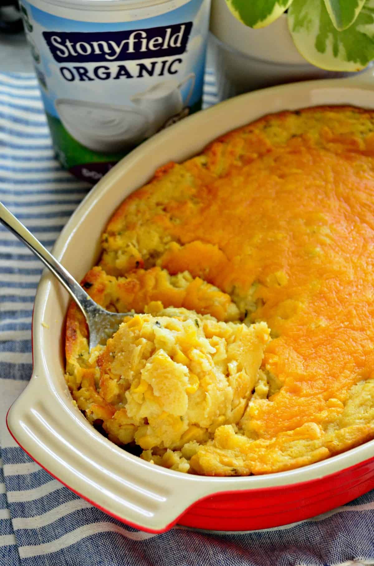 top view of Double Cream Corn Casserole with spoon scooped into in and title text.