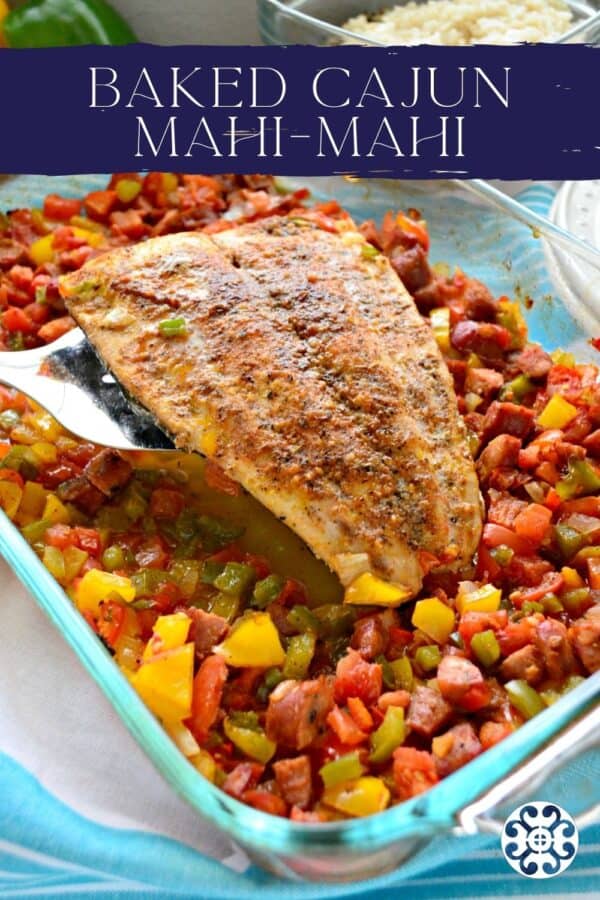 Silver spatula holding a mahi filet with peppers and sausage with text on image for Pinterest.