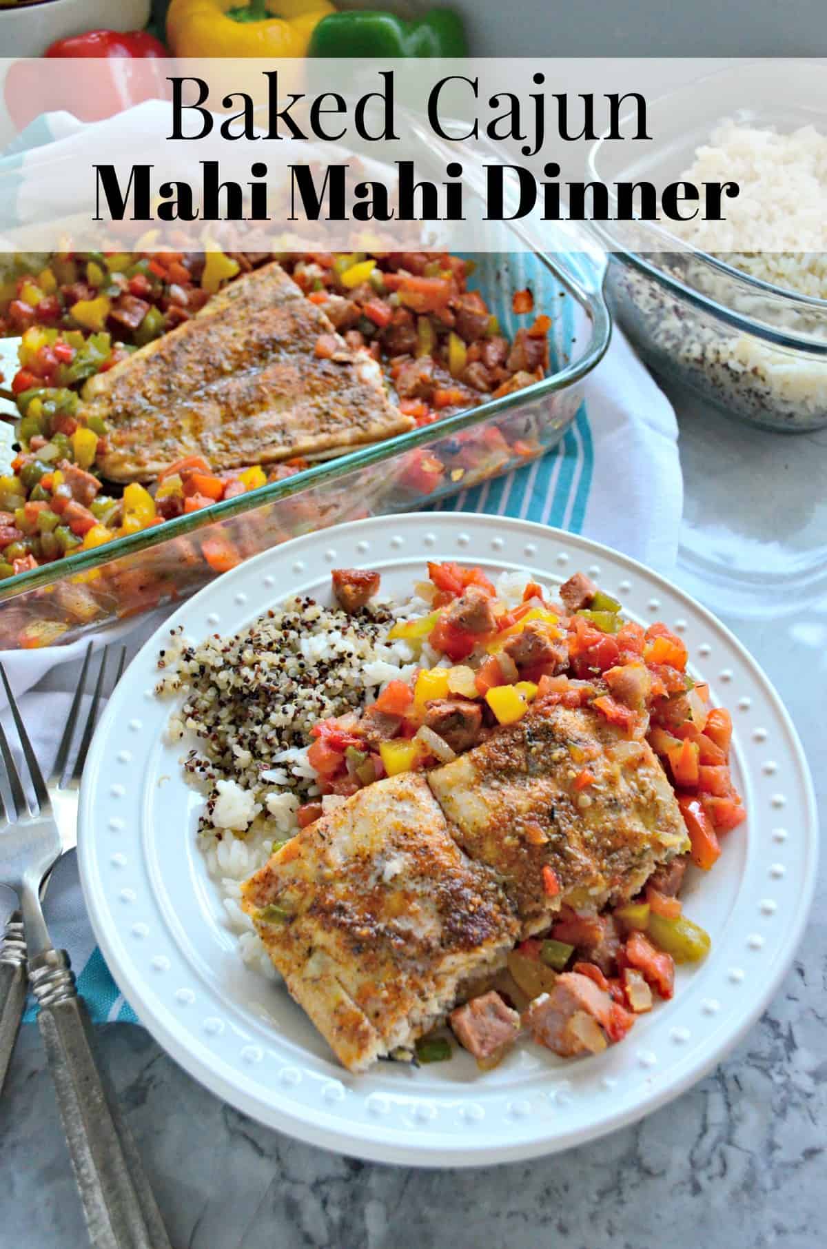 top view of plated baked mahi mahi with chopped veggies and sausage on bed of rice and quinoa.