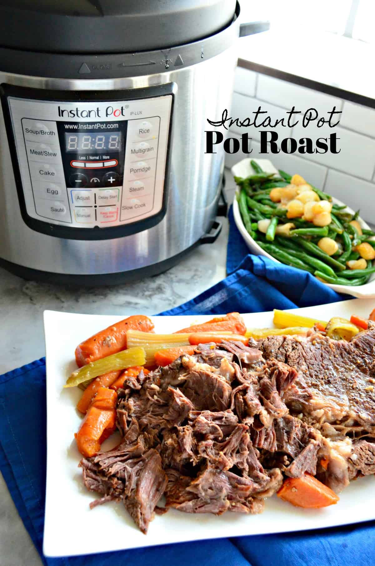 platter of pot roast with carrots and celery in front of instant pot and green bean platter.