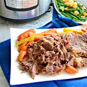 White platter filled with shredded beef, carrots, and celery.