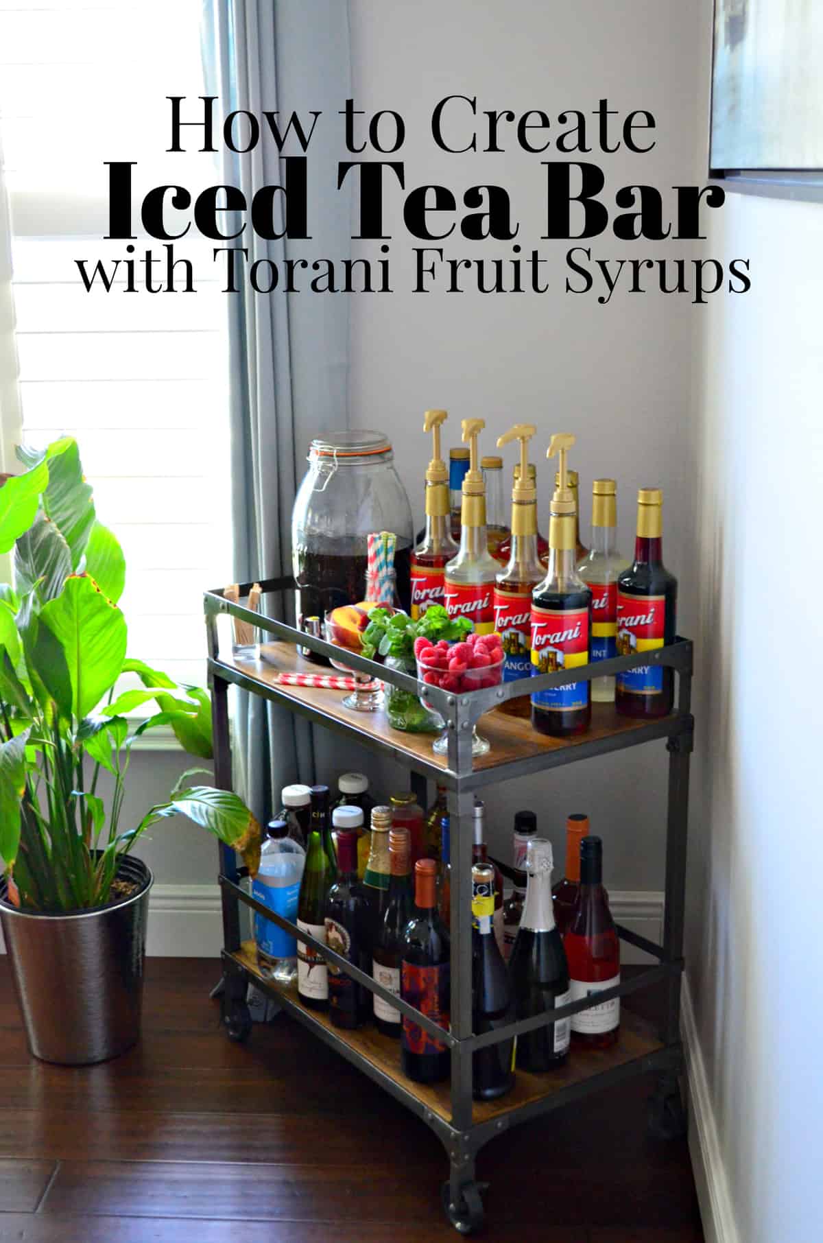 bar cart with 10 torani syrup flavors decoratively placed with mint, raspberries, peaches, and straws.