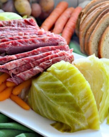 Instant Pot Corned Beef & Cabbage on a platter with rye bread on the side