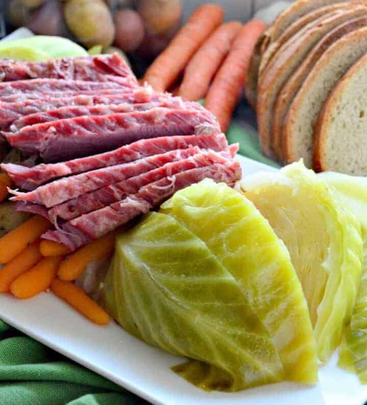 Instant Pot Corned Beef & Cabbage on a platter with rye bread on the side