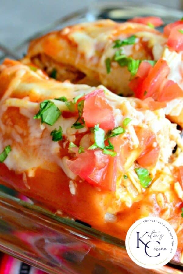 Close up of enchiladas in a baking dish with a logo on the right bottom corner.