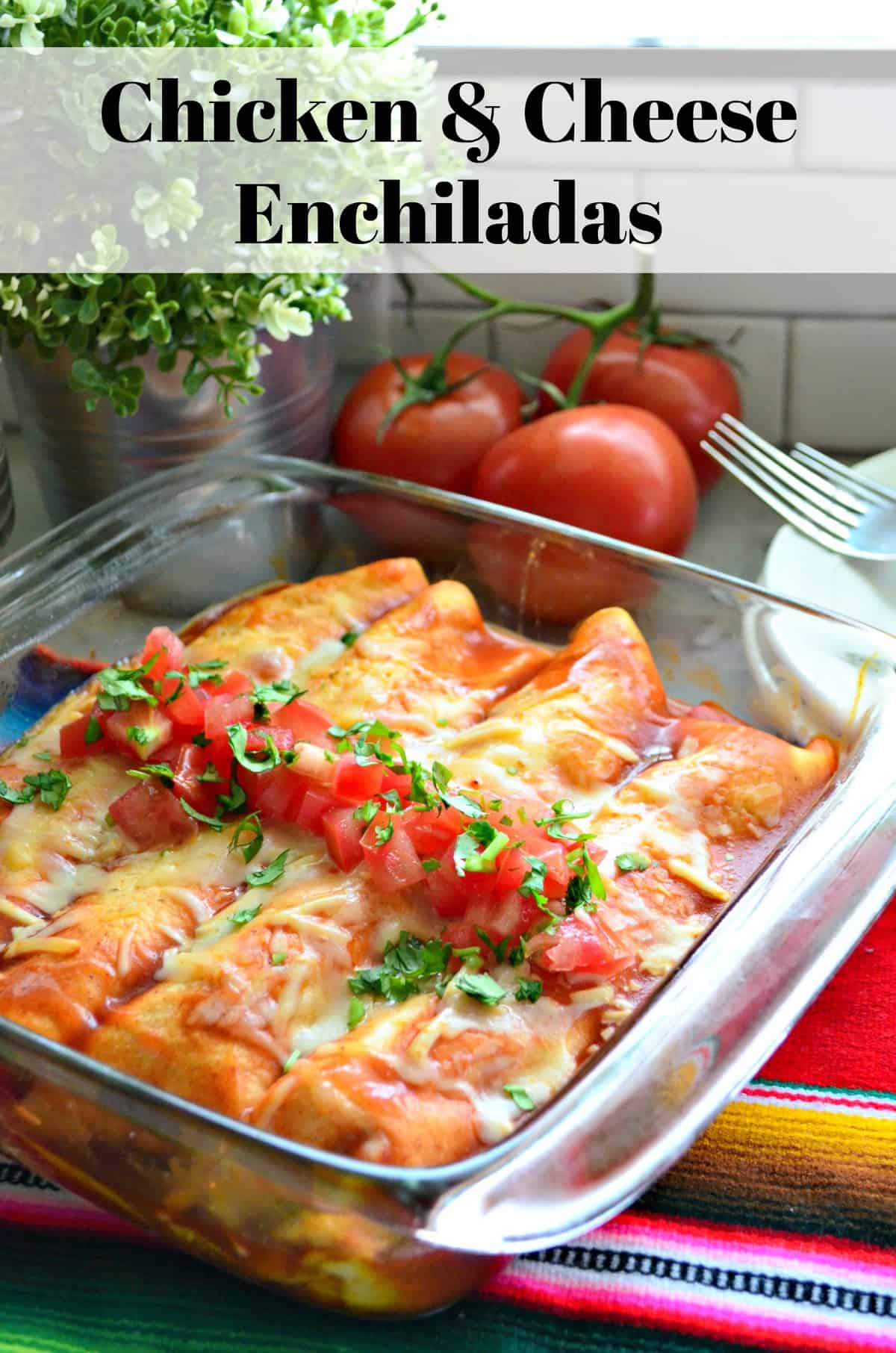 Enchiladas in glass dish topped with melted cheese, diced tomatoes, and cilantro with title text.