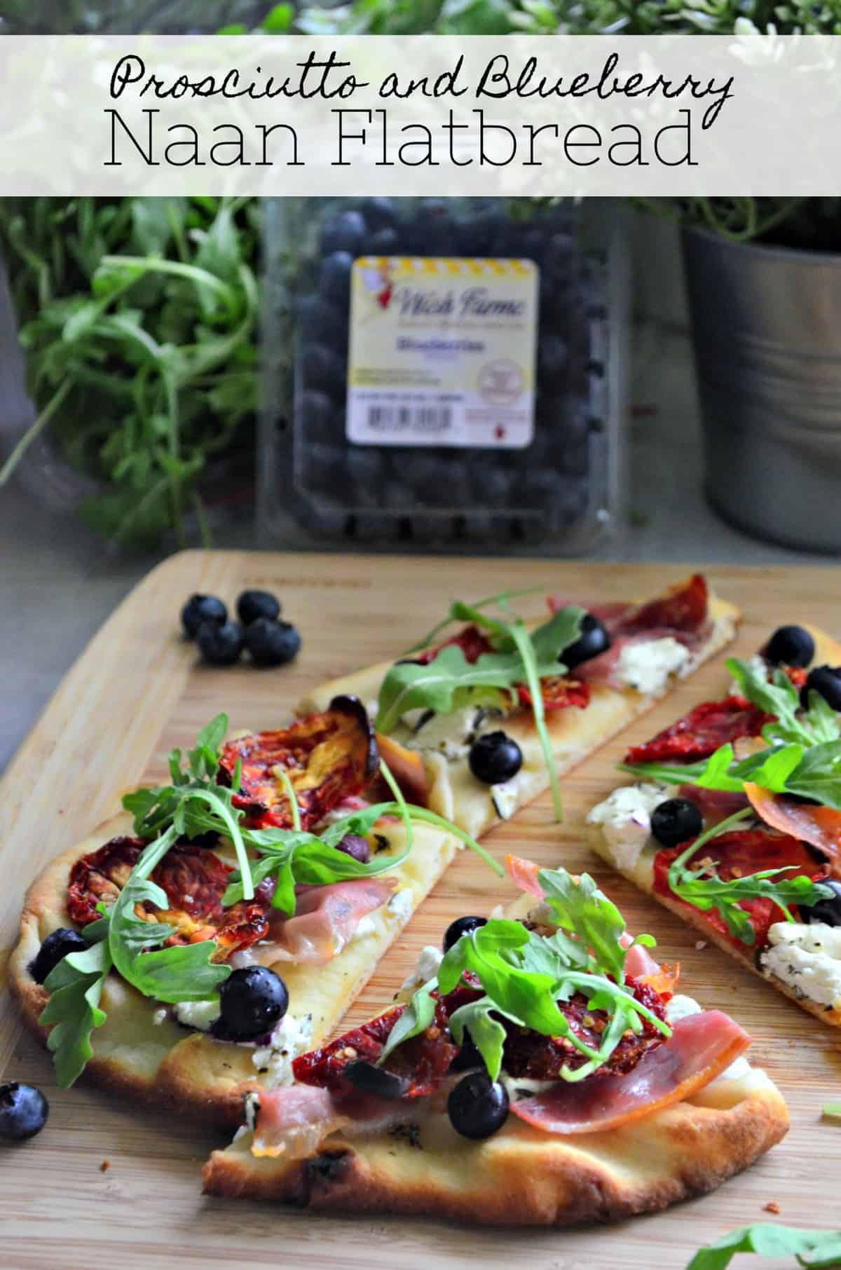 Flatbread topped with prosiutto, arugula, blueberries, cheese, and sundried tomato with title text.