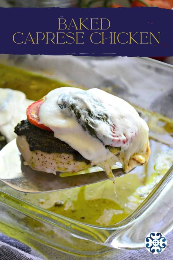 Spatula lifting chicken breast, topped with tomato, pesto, and cheese.